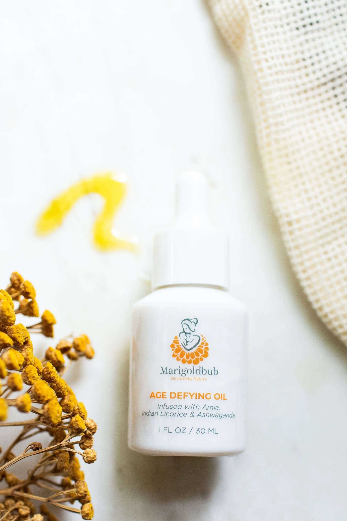 Deep Hydration Ritual with a white bottle of Age Defying Oil, featuring a white cap and colorful botanical label