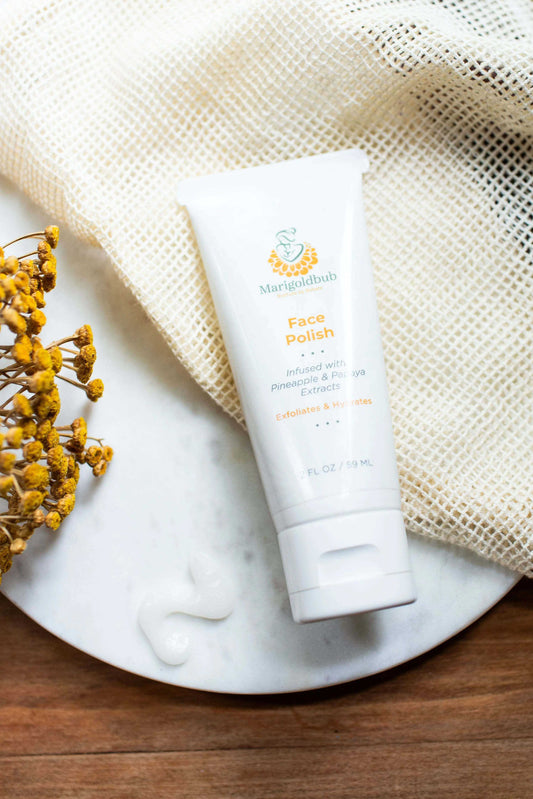Skin polish in a white tube with orange and green botanical branding, labelled face polish with pineapple and papaya extracts
