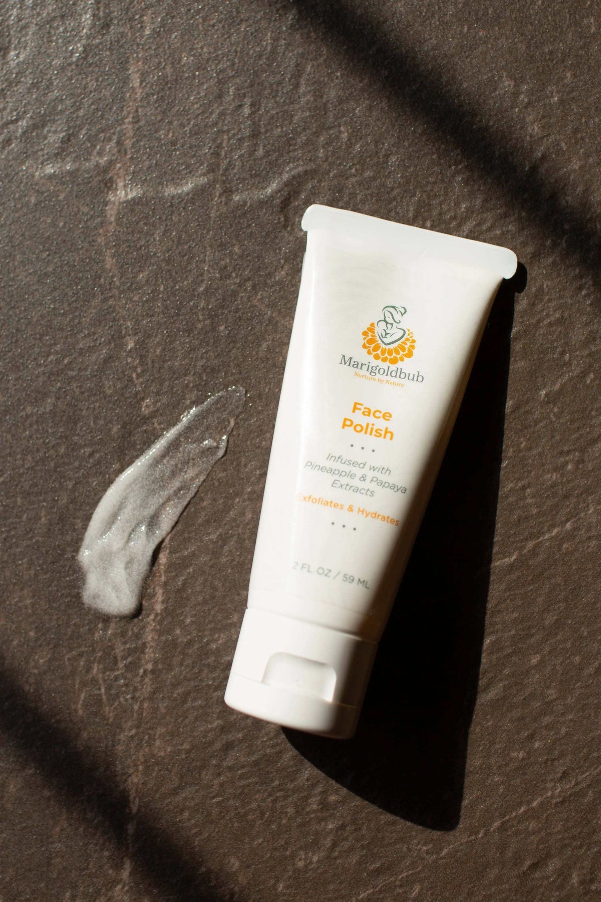 Pineapple and Papaya Skin Polish in a white squeeze tube with an orange and green label and flip-top cap
