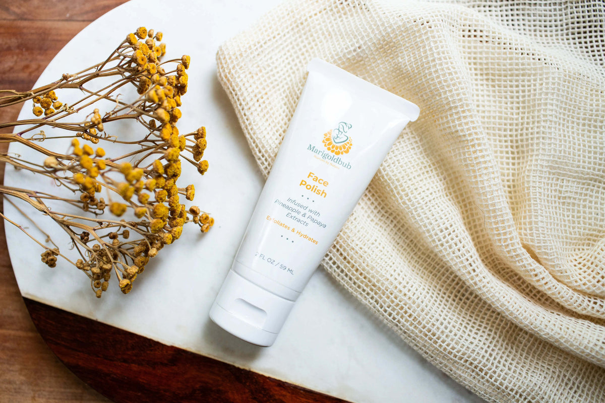 Pineapple and Papaya Skin Polish in a white tube with a yellow and teal label, featuring a flip-top cap